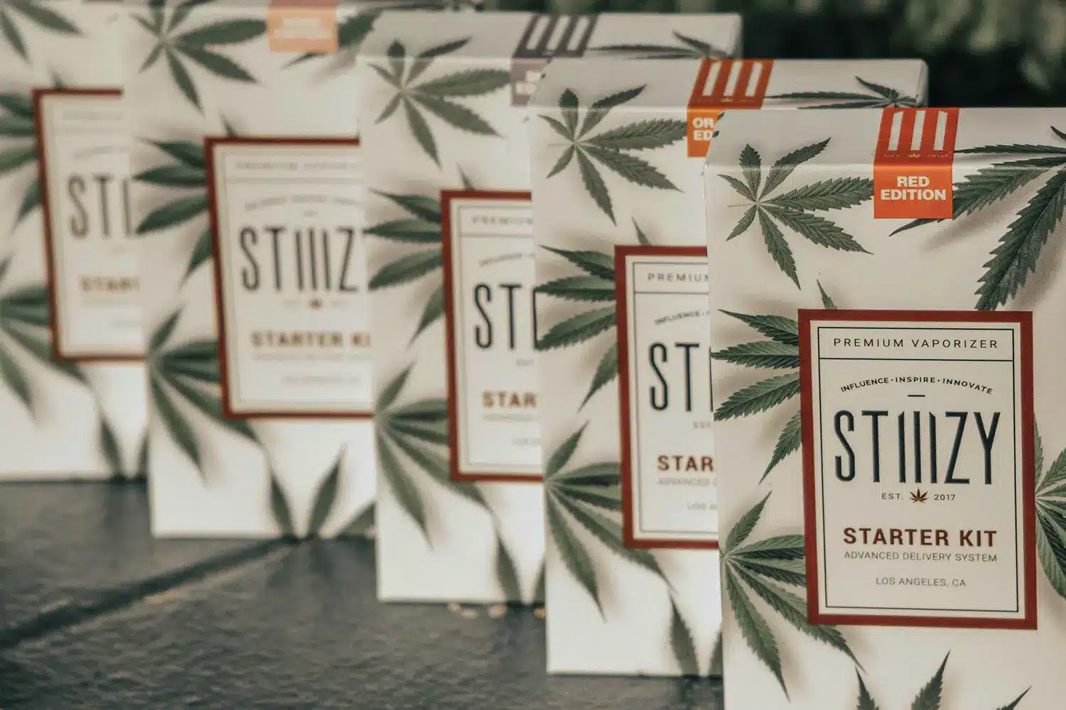 Stiiizy Starter Kits lined up, showcasing the premium vaporizer packaging with cannabis leaf design.