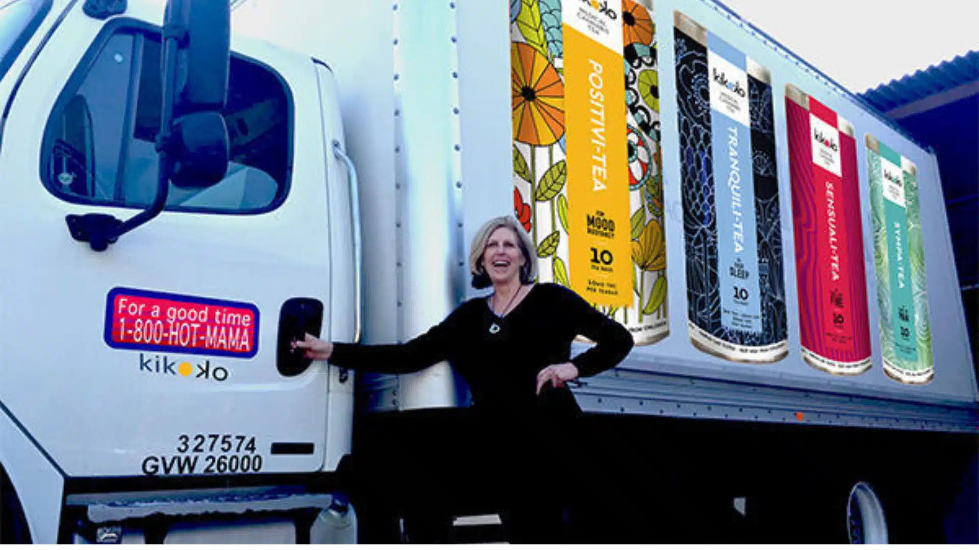 One of Kikoko's founders smiling beside a delivery truck showcasing colorful designs of cannabis-infused teas. The image represents the brand's commitment to wellness, creativity, and leadership in the cannabis space.