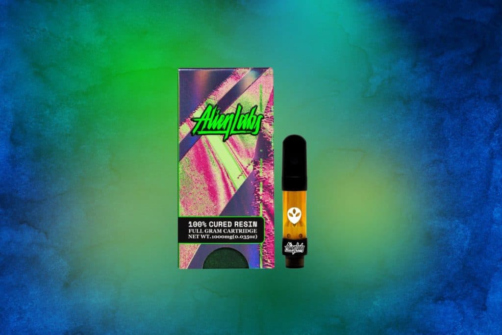 Alien Labs 100% Cured Resin Full Gram Cartridge against a vibrant blue and green background.