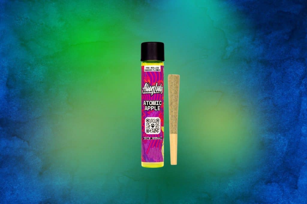 Alien Labs Atomic Apple Pre-Roll in a vibrant tube with a blue and green background.