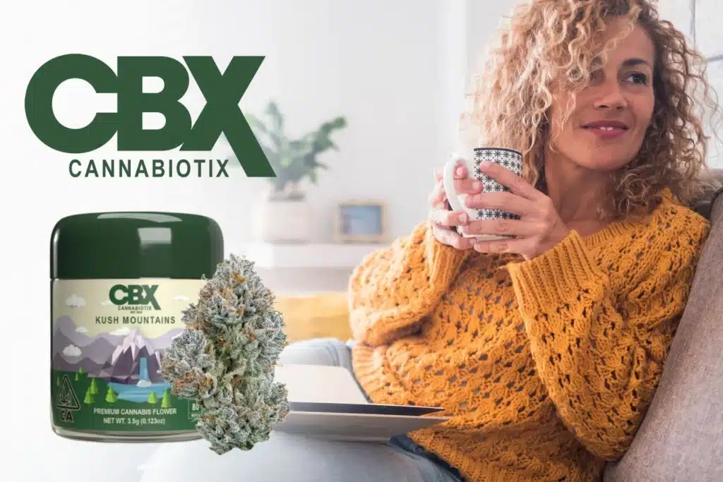 A cozy scene featuring a woman in a mustard-yellow sweater holding a warm cup while relaxing on a couch. The CBX (Cannabiotix) logo is prominently displayed on the left, alongside a jar of CBX Kush Mountains premium cannabis flower and a detailed cannabis bud. The background is softly blurred, highlighting a peaceful home atmosphere. 