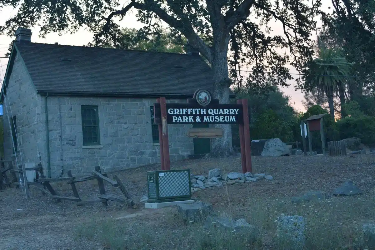 griffith-quarry-park The rustic entrance sign for Griffith Quarry Park & Museum in Penryn, CA, with the historic stone museum building in the background.